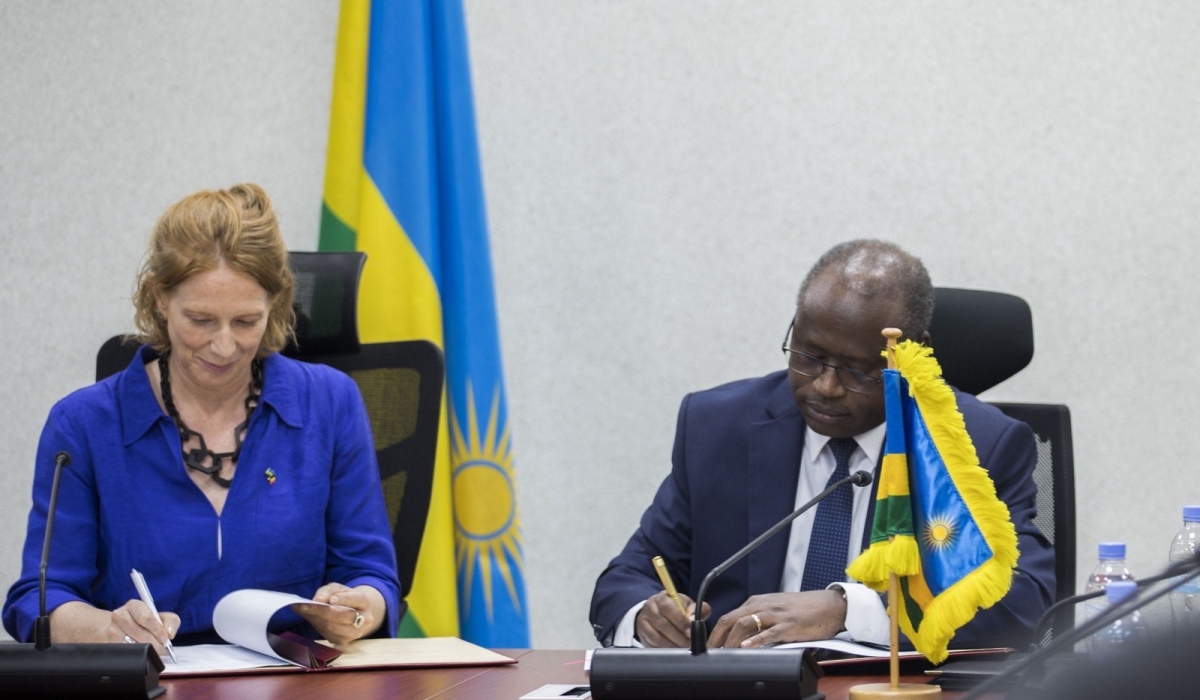 Minister of Finance and Economic Planning, Uzziel Ndagijimana (R), and Heidy Rombouts, Director General of Development Cooperation at the Belgian Ministry of Foreign Affairs and Development Cooperation, sign a cooperation agreement in Kigali on Tuesday, January 30. All photos by Craish Bahizi