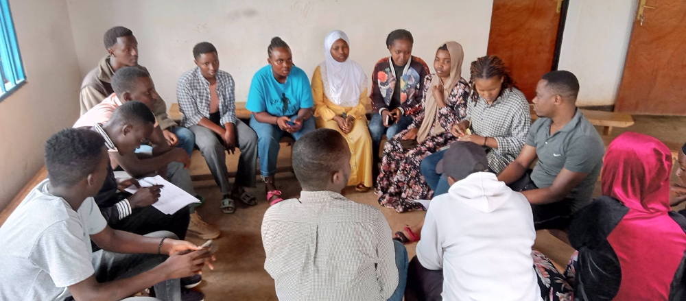 A group of youths born from genocide survivors and perpetrators are gathered in a reconciliation group. Photo by Emmanuel Nkangura