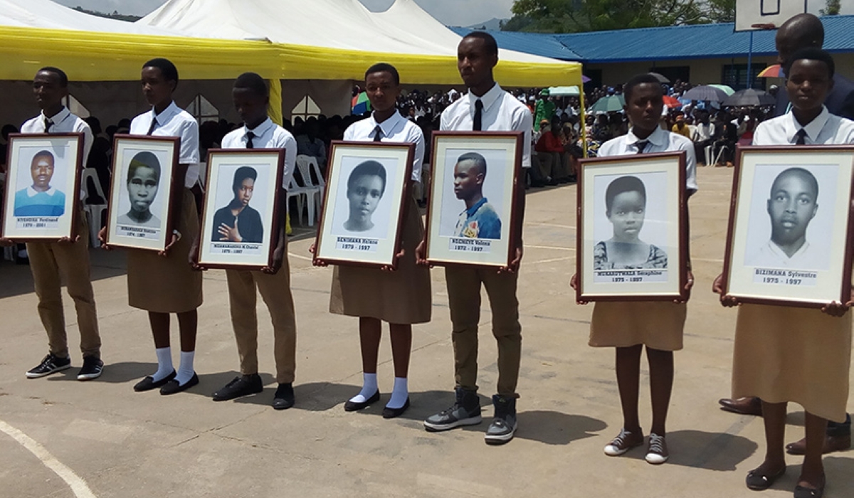 Students hold portraits of the Nyange heroes during a commemoration event at Ecole Secondaire de Nyange in Ngororero District, in 2019. Courtesy