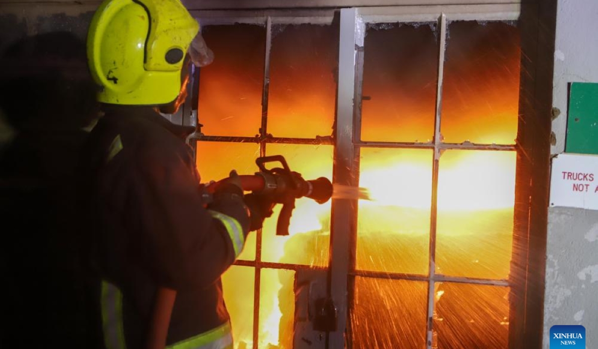 A firefighter works at the site of a fire resulting from a gas explosion in the Embakasi neighborhood in Nairobi, Kenya, Feb. 2, 2024. At least two people were killed and 222 others injured in an inferno resulting from a gas explosion in the capital of Kenya here, an official confirmed on Friday morning.(Photo by Joy Nabukewa/Xinhua)