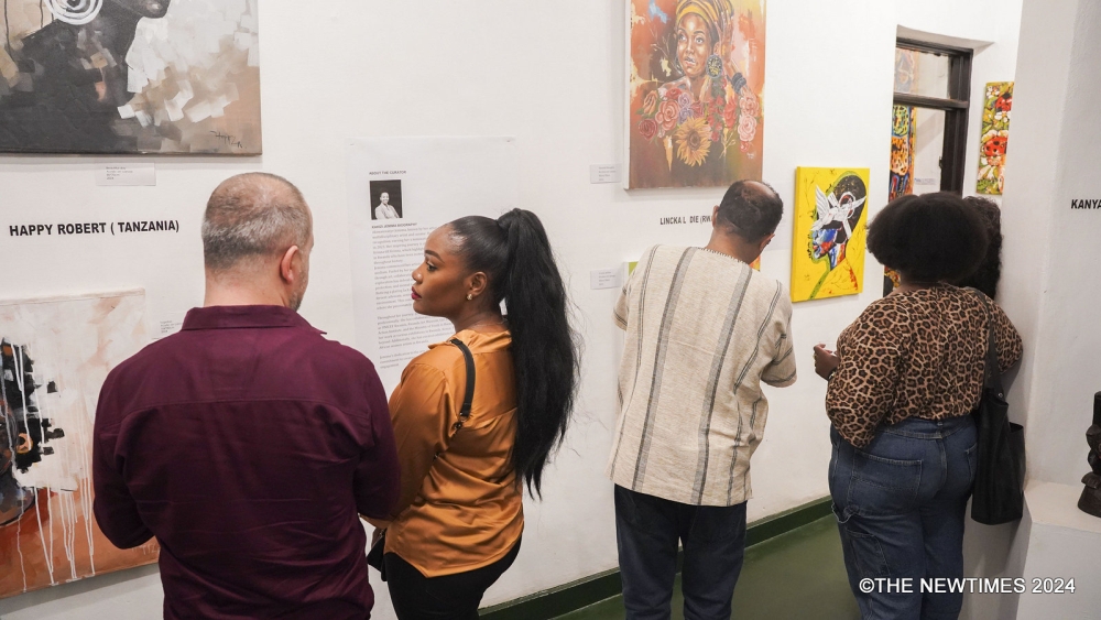 Some visitors tour the newly launched exhibition that displays different artworks made by local artists. All photos by Craish Bahizi