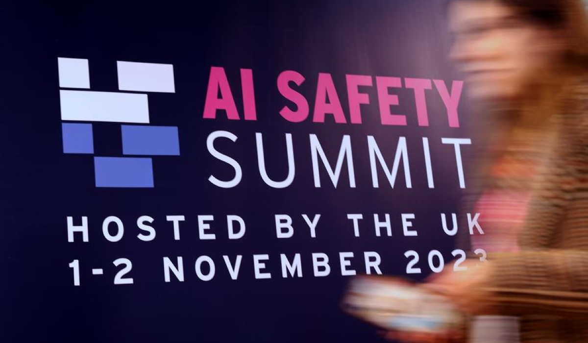 An attendee walks past a billboard of AI Safety Summit in Bletchley Park, Britain, Nov. 2, 2023. A global summit on artificial intelligence (AI) safety was held at Bletchley Park on Nov. 1 to 2. The Chinese delegation attending the summit participated in discussions on AI safety and other issues, promoted China&#039;s Global Artificial Intelligence Governance Initiative, and carried out bilateral talks with relevant countries.v(Xinhua/Li Ying)