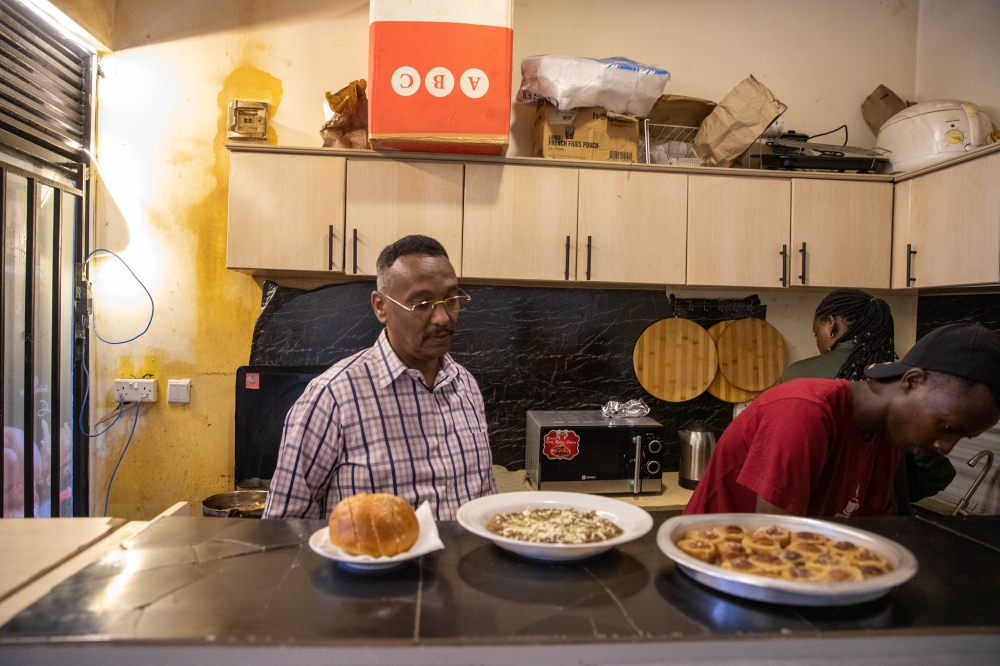 Engineer Adil Hassan Abdelmagid Mohamed busy at his fast food restaurant. Photos by Willy Mucyo.