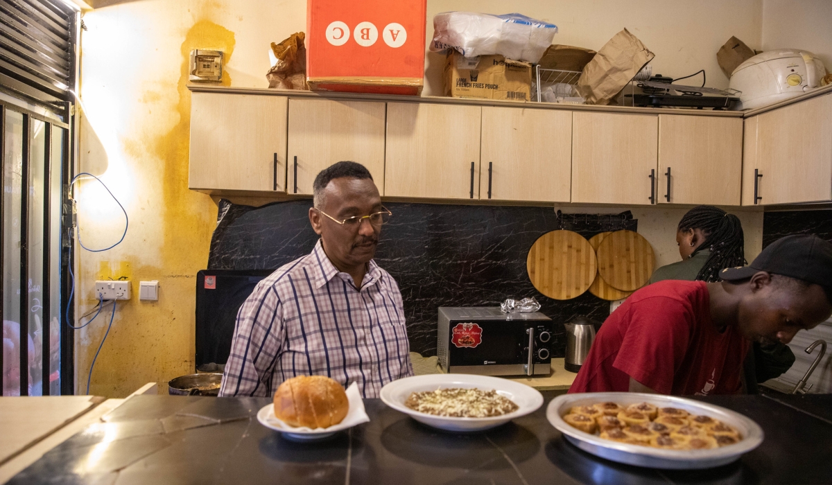 Engineer Adil Hassan Abdelmagid Mohamed busy at his fast food restaurant. Photos by Willy Mucyo.