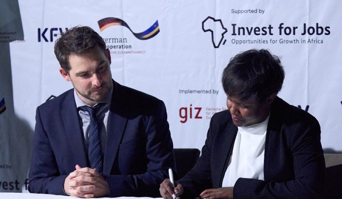 Ariane Inkesha of Solid’Africa signing the finance agreement with Steffen Khul the MD of IFE 