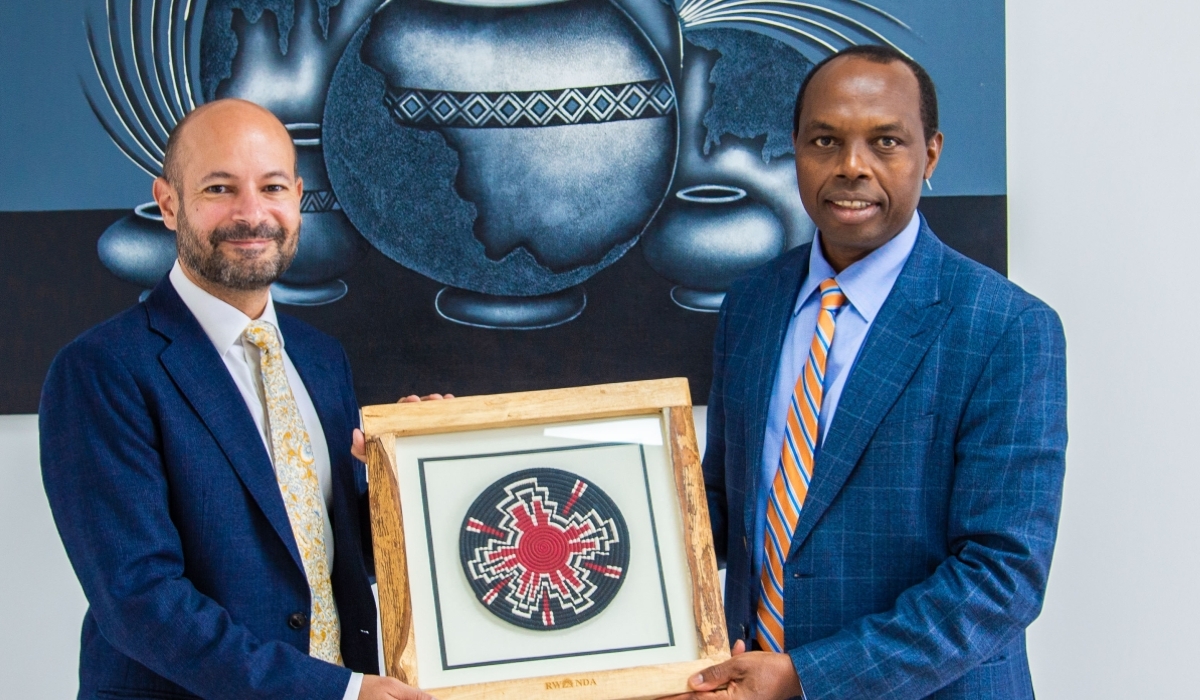 Francis Gatare, the CEO of Rwanda Development Board and Omar Daair, the UK High Commissioner to Rwanda exchange a gift. Courtesy