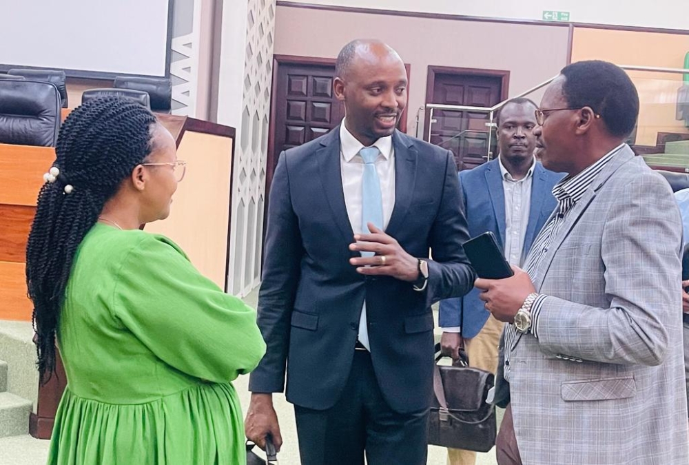 Health Minister Sabin Nsanzimana (C) chats with senators Cyprien Niyomugabo (R), and Adrie Umuhire in the Senate’s plenary hall, soon after the session on Rwanda’s efforts to prevent and deal with epidemics concluded, on February 19, 2024. Dr. Edson Rwagasore, Division Manager of Public Health Surveillance and Emergency Preparedness and Response at RBC, is seen in the background (Emmanuel Ntirenganya).