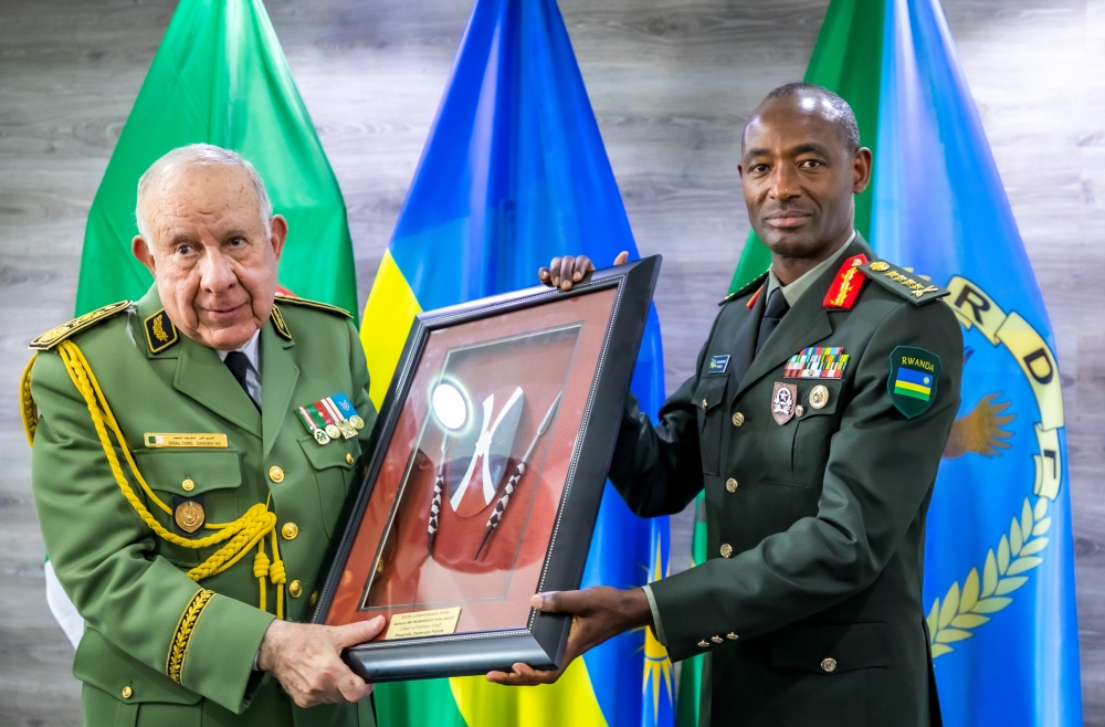 General Saïd Chanegriha (L) receives a gift from Gen Mubarakh Muganga, the Rwanda Defence Force Chief of Defence Staff. Photo/Courtesy
