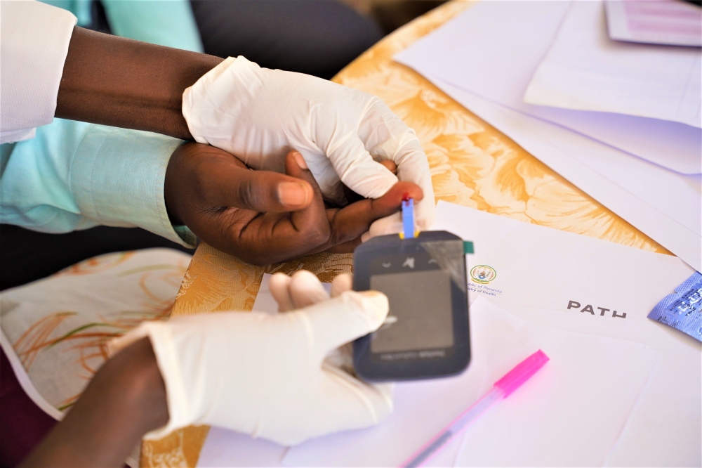 A medical practitioner collects a blood sample from a patient during an NCD screening exercise in Kigali on July 26, 2022. Diabetes is one of the most common NCDs and is characterised by high levels of sugar (glucose) in the blood. Photo by Craish Bahizi
