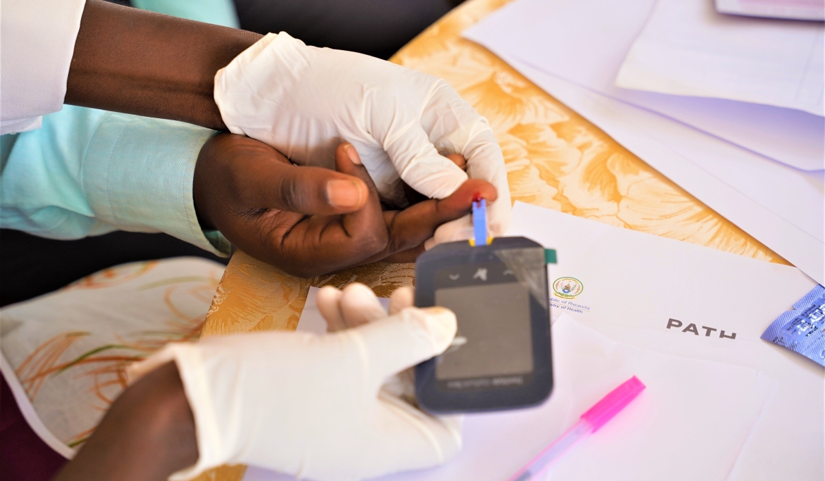 A medical practitioner collects a blood sample from a patient during an NCD screening exercise in Kigali on July 26, 2022. Diabetes is one of the most common NCDs and is characterised by high levels of sugar (glucose) in the blood. Photo by Craish Bahizi