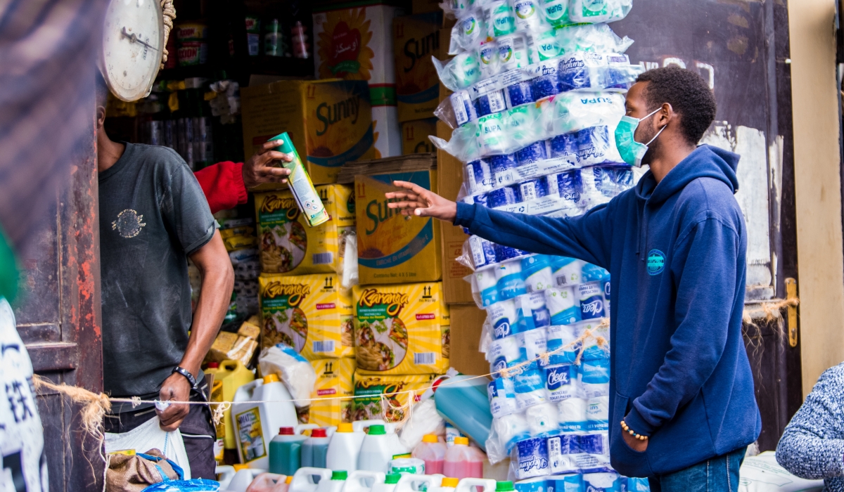 A client buys some products at Nyarugenge Market. Craish Bahizi