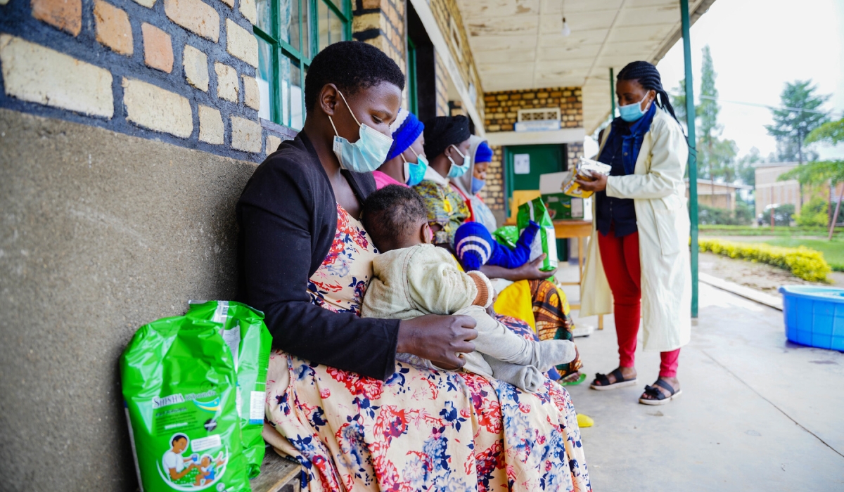 Parents waiting to receive packets of Shisha Kibondo. The nutritious porridge is part of the government’s efforts to address malnutrition and stunting in children. Photo by Craish Bahizi