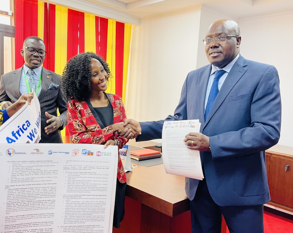 EALA Speaker Joseph Ntakirutimana (R), receives the petition on public services in the East African Community partner states, from Allana Kembabazi, programme manager at Initiative for Social and Economic Rights (L), in Nairobi, Kenya, as EALA MP Gerald Blacks Siranda Gerald looks on, on March 12, 2024. PHOTOS BY EMMANUEL NTIRENGANYA