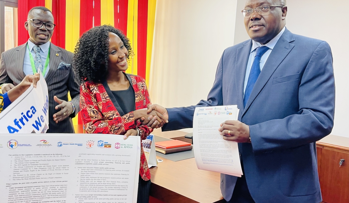 EALA Speaker Joseph Ntakirutimana (R), receives the petition on public services in the East African Community partner states, from Allana Kembabazi, programme manager at Initiative for Social and Economic Rights (L), in Nairobi, Kenya, as EALA MP Gerald Blacks Siranda Gerald looks on, on March 12, 2024. PHOTOS BY EMMANUEL NTIRENGANYA