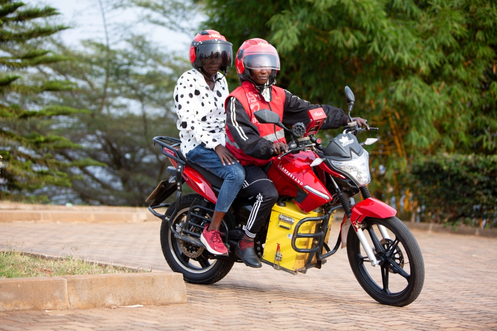 A female taxi moto driver Josie Nsanzingoma rides  an  Ampersand E-motorbike in Kigali. File