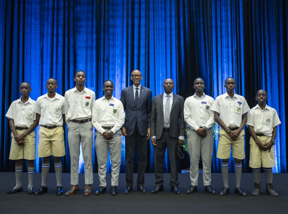 President Paul Kagame and Ntare School (Uganda) Headmaster Saul Rwampororo pose for a picture with current students of the school in western Uganda during a cocktail at Kigali Convention Centre on Friday, March 8. VILLAGE URUGWIRO