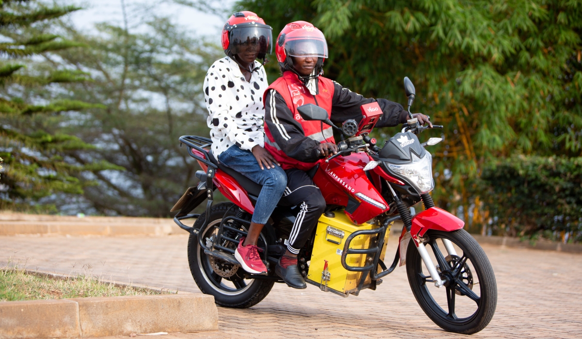 A female taxi moto driver Josie Nsanzingoma rides  an  Ampersand E-motorbike in Kigali. File