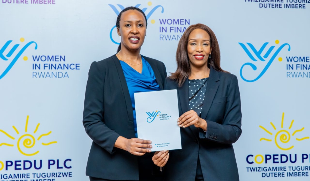 Raissa Muyango, the Managing Director of Copedu Plc and Lina Higiro, the Chairperson of Women in Finance Rwanda pose for a photo after signing