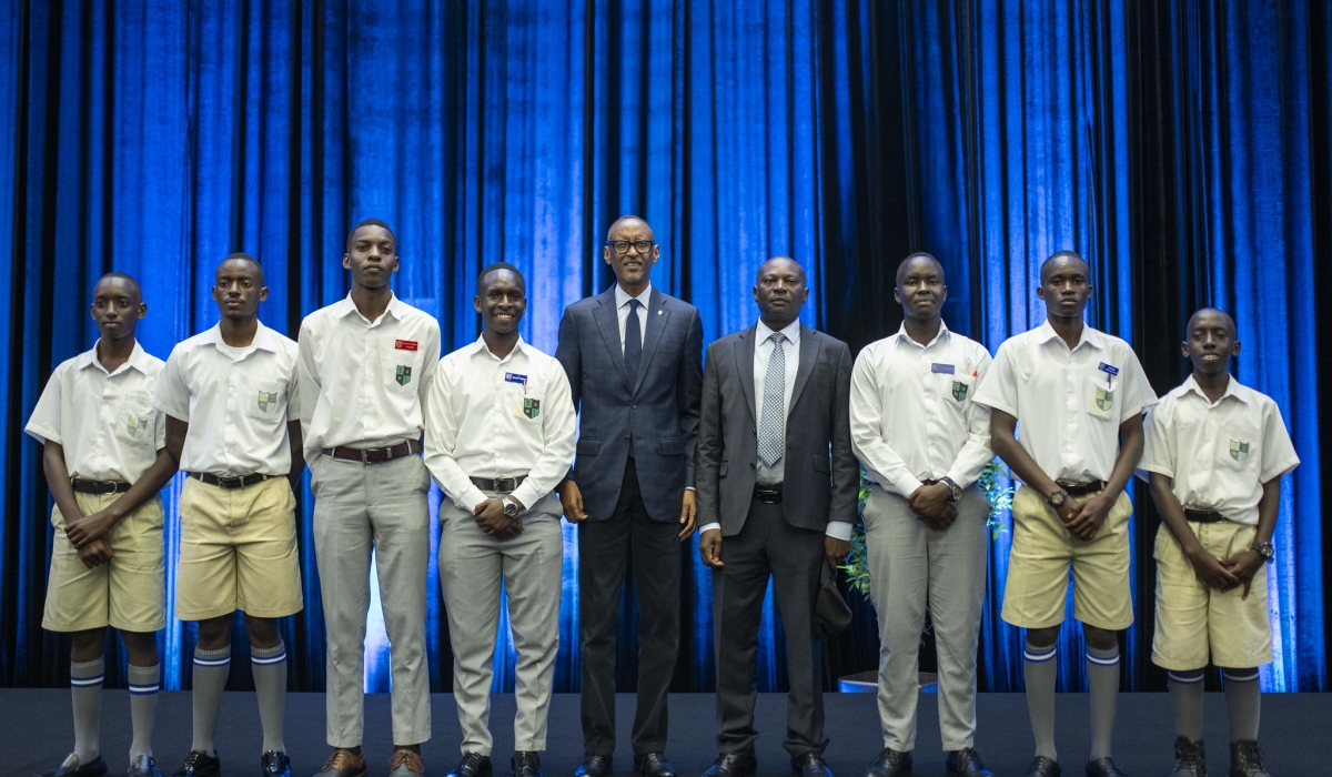 President Paul Kagame and Ntare School (Uganda) Headmaster Saul Rwampororo pose for a picture with current students of the school in western Uganda during a cocktail at Kigali Convention Centre on Friday, March 8. VILLAGE URUGWIRO