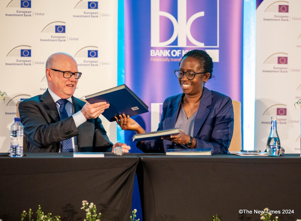 Thomas Ostros, European Investment Bank (EIB Global) Vice President and Dianne Karusisi , Chief Executive Officer of Bank of Kigali exchange documents during the signing ceremony in Kigali on Thursday, March 14. All Photos by Dan Gatsinzi