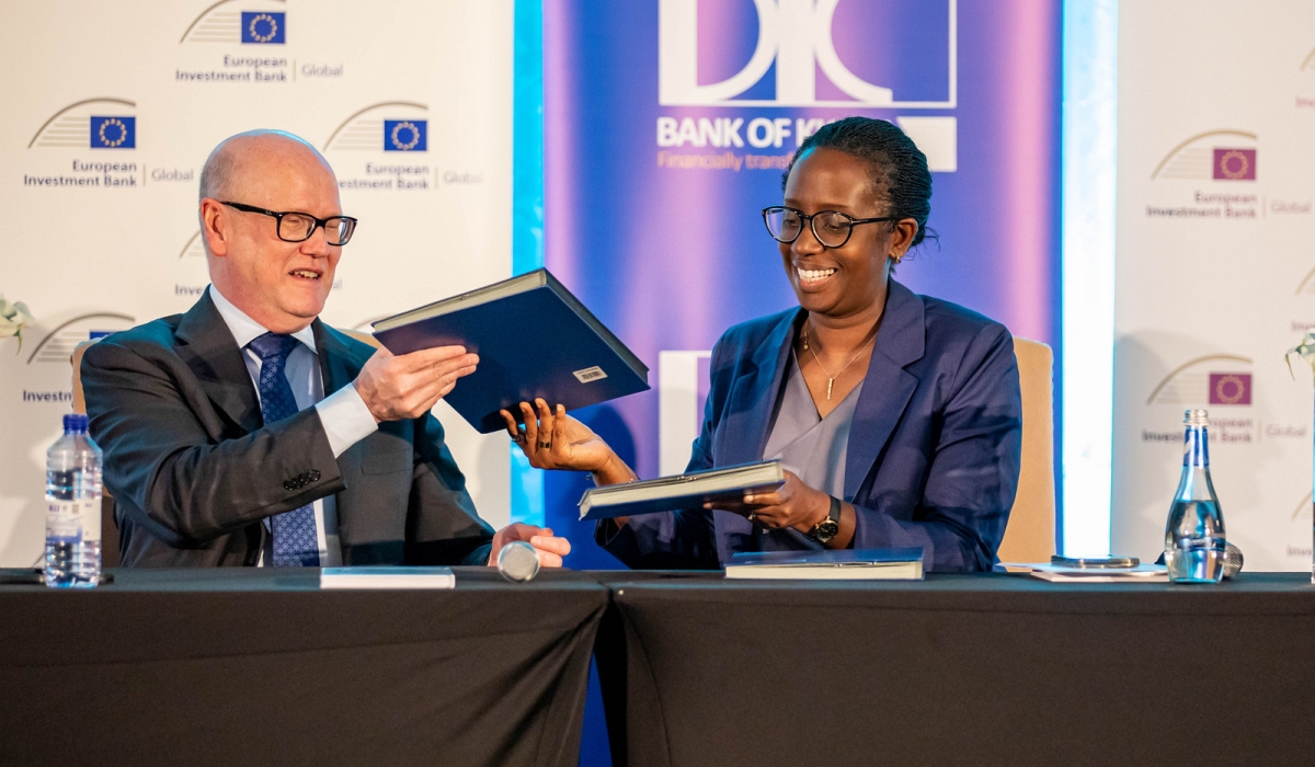 Thomas Ostros, European Investment Bank (EIB Global) Vice President and Dianne Karusisi , Chief Executive Officer of Bank of Kigali exchange documents during the signing ceremony in Kigali on Thursday, March 14. All Photos by Dan Gatsinzi