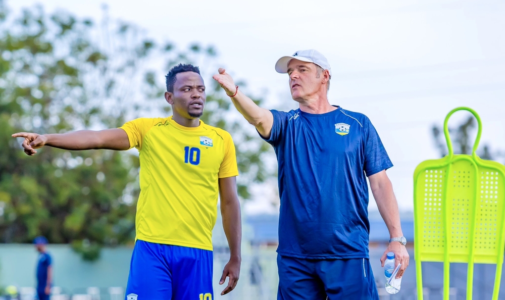 National football team (Amavubi) head coach Frank Spittler Torsten gives instructions to Muhadjili Hakizimana during a training session at Bugesera Stadium.