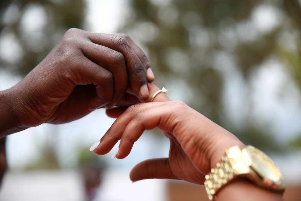 A bride and groom  during a wedding ceremony. . Sam Ngendahimana