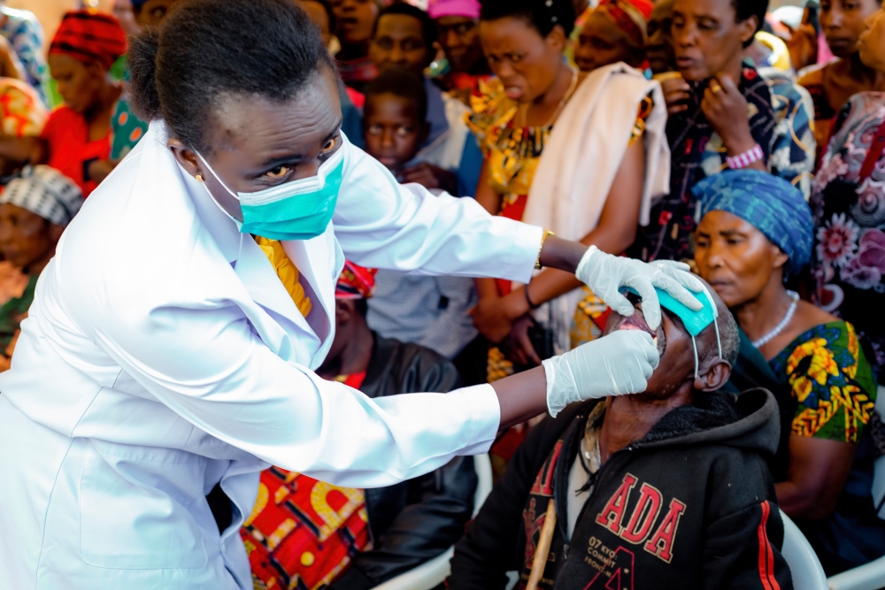 A medic conducting oral screening  during the observation of World Oral Health Day   at Gikomero Stadium in Gasabo district on March 20. Courtesy
