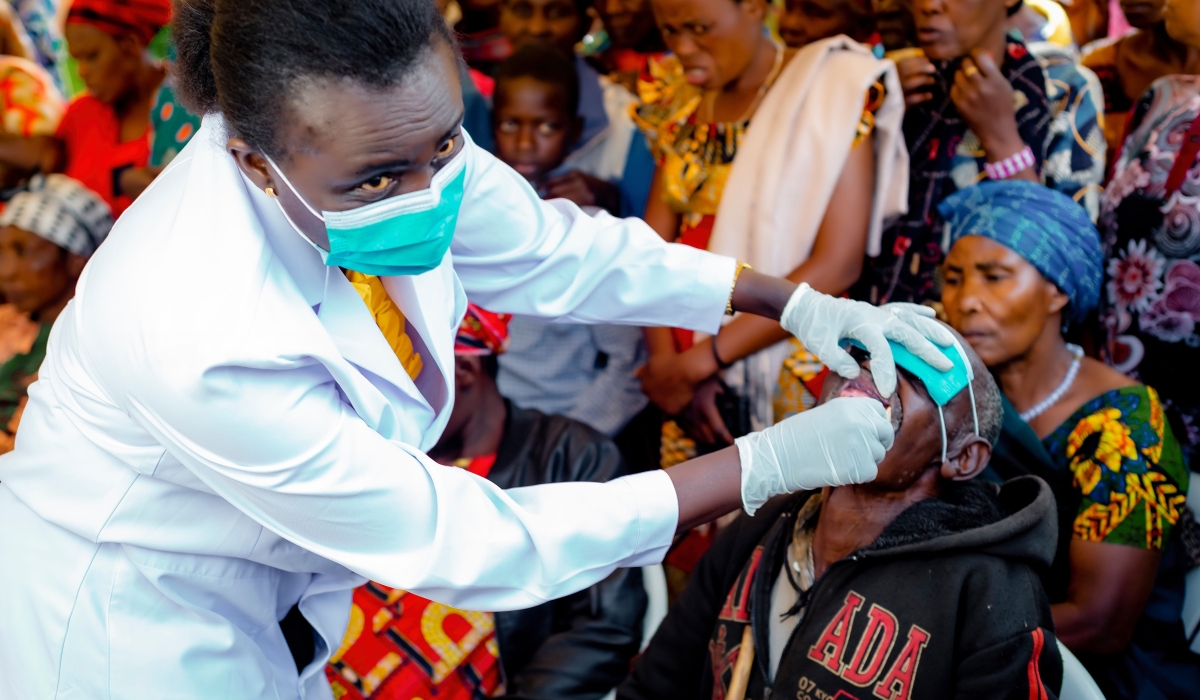 A medic conducting oral screening  during the observation of World Oral Health Day   at Gikomero Stadium in Gasabo district on March 20. Courtesy