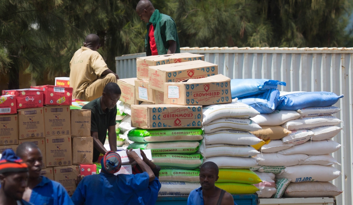 Workers load some of the imported food commodities for upcountry trading at Kigali Business District. File