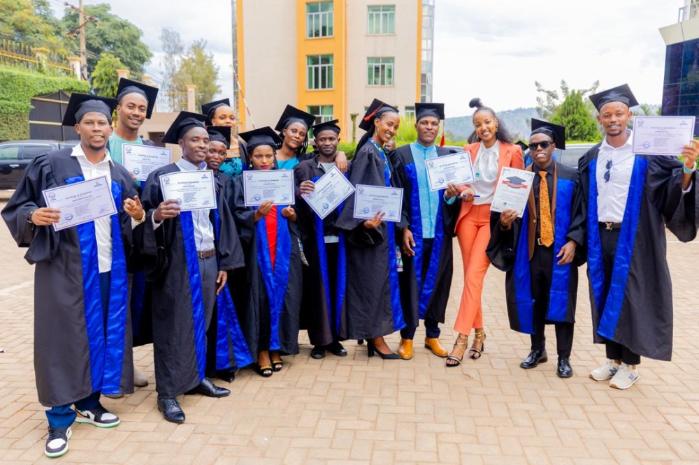 Graduates pose for a group photo with their certificates at the ceremony on March 22.