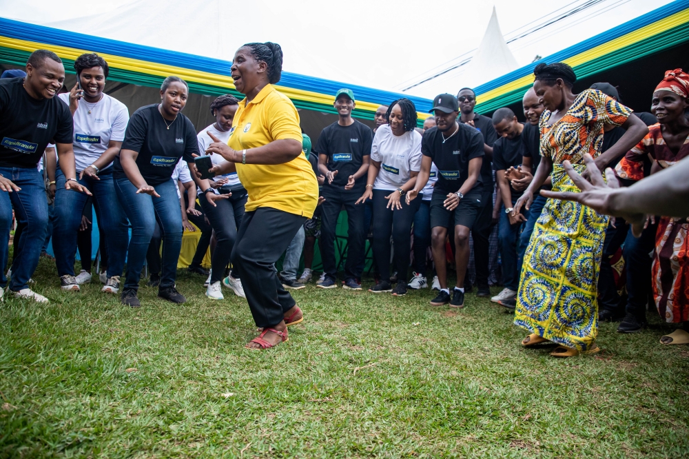 Residents of Ruliba cell who are beneficiaries of Ecobank&#039;s support dance with the bank&#039;s staff at the event. All photos by Dan Gatsinzi