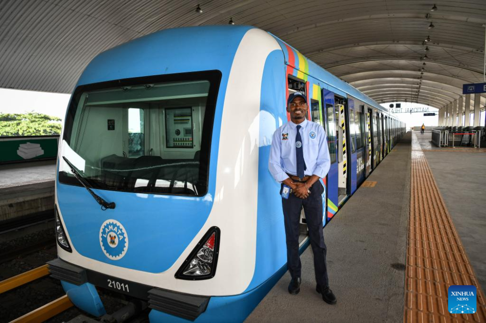 A local driver is pictured beside a train of the Lagos Rail Mass Transit (LRMT) Blue Line in Lagos, Nigeria, March 2, 2024. (Xinhua/Han Xu)