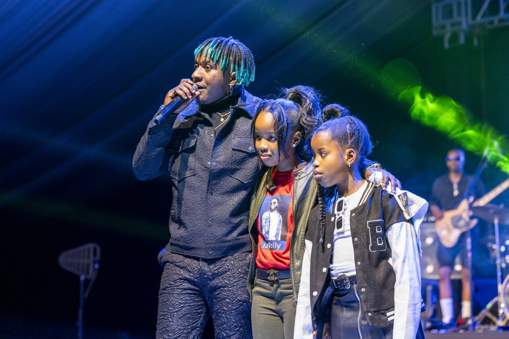 Artiste Platini Nemeye introduces Late Jay Polly&#039;s children to the audience during his first solo concert dubbed &#039;BABA Experience&#039; at Kigali Conference and Exhibition Village on Saturday, March 30.  All Photos by Olivier Mugwiza