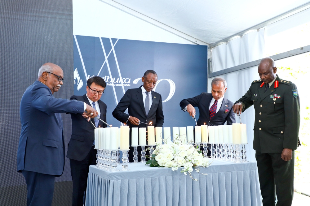 The Ambassador of the Republic of Rwanda to China, James Kimonyo(c) with other senior delegates light candles during the commemoration of Genocide in China on April 7. Courtesy