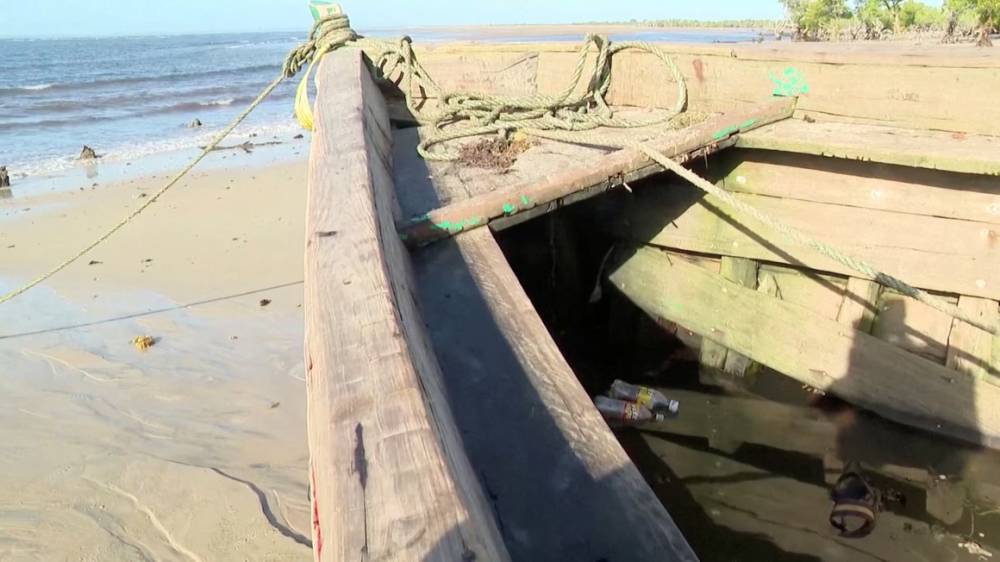 A ferry sits on the shore, which according to an official was unlicensed, following an accident in Nampula Province, Mozambique, in this screen grab obtained from a video on April 8, 2024. PHOTO _ REUTERS