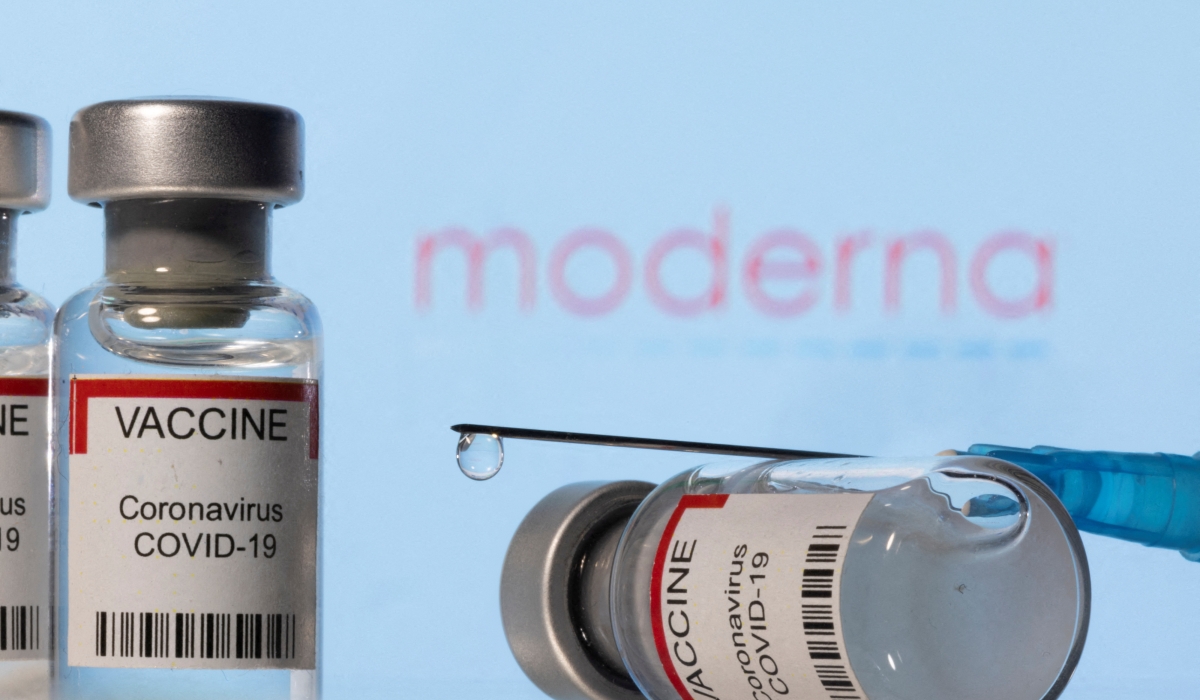 ials labelled "VACCINE Coronavirus COVID-19" and a syringe are seen in front of a displayed Moderna logo in this illustration taken December 11, 2021. REUTERS/Dado Ruvic