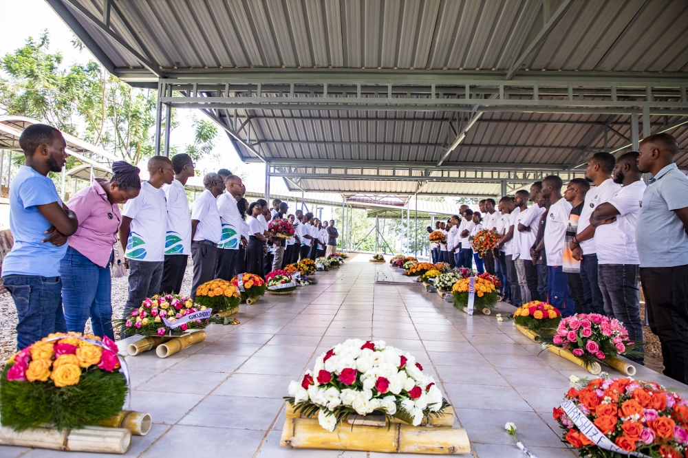 Management and staff of  NETIS Rwanda,  observe a moment of silence to pay tribute to the victims of the 1994 Genocide at Nyanza-Kicukiro  Genocide Memorial on April 12. Photos by Emmanuel Dushimimana