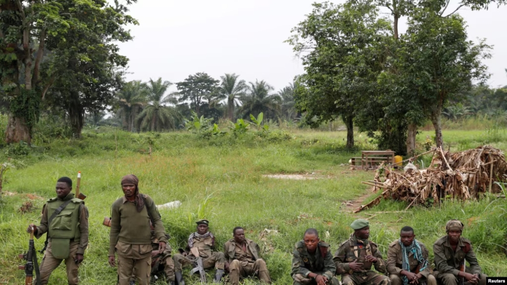 Armed Forces of the Democratic Republic of the Congo soldiers rest next to a road after Islamist rebel group called the Allied Democratic Forces (ADF) attacked area around Mukoko village, North Kivu province of Democratic Republic of Congo, December 11, 2018.