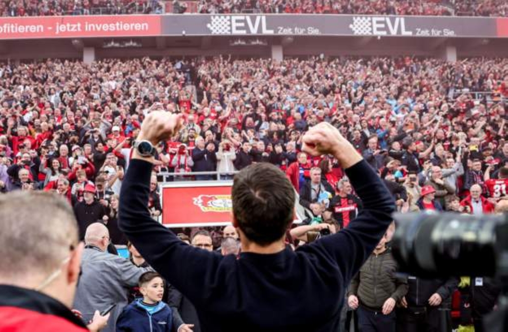 An extremely excited Xabi Alonso salutes Bayer Leverkusen fans inside BayArena after helping the club win their first Bunseliga title on Sunday, April 14, with five games to spare-Phot by Rex Features