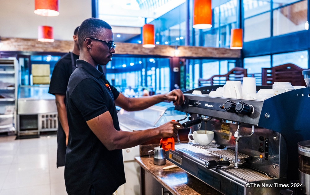 A barista prepares coffee for clients at Bourbon Coffee MTN Centre Branch in Kigali on March 27, 2024. Photo by Chelsea Nkubito
