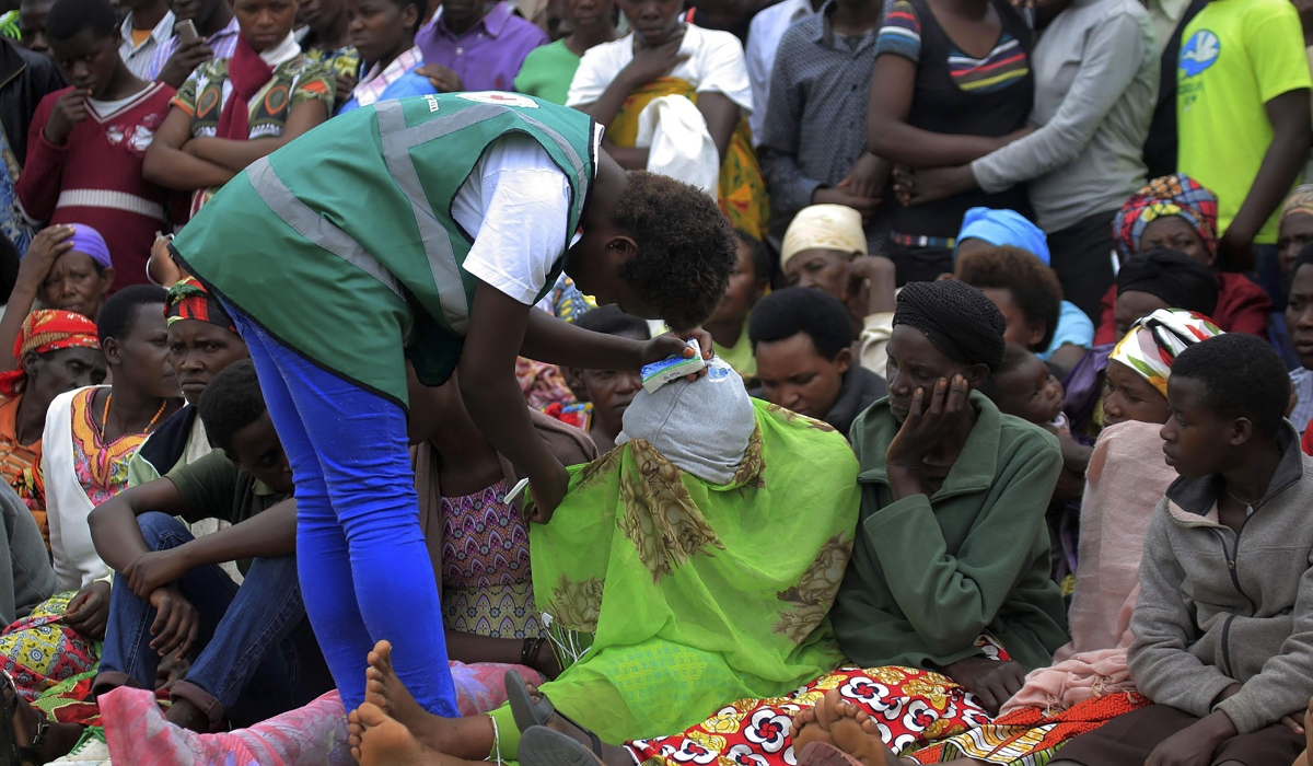 A volunteer comforts a victim during a past commemoration event at Murambi Genocide Memorial in Nyamagabe District. The 1994 Genocide against the Tutsi caused severe psychological and emotional wounds, leading to depression, anxiety, and social phobia, among survivors. File photo