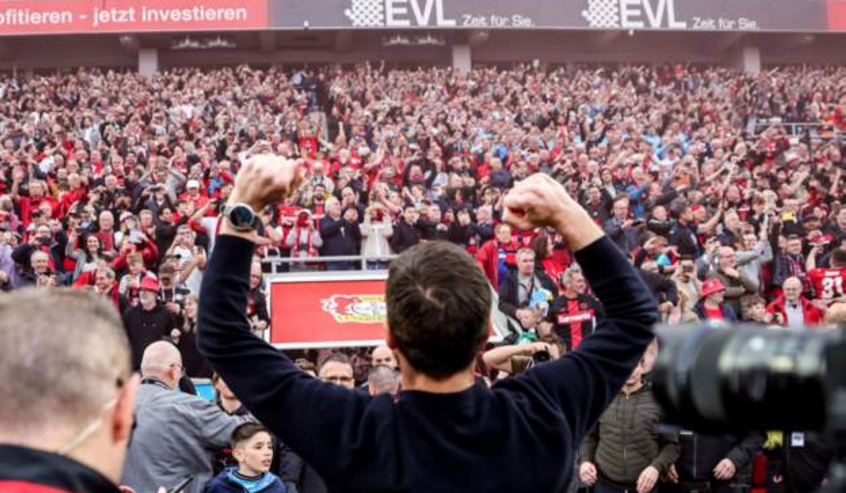 An extremely excited Xabi Alonso salutes Bayer Leverkusen fans inside BayArena after helping the club win their first Bunseliga title on Sunday, April 14, with five games to spare-Phot by Rex Features