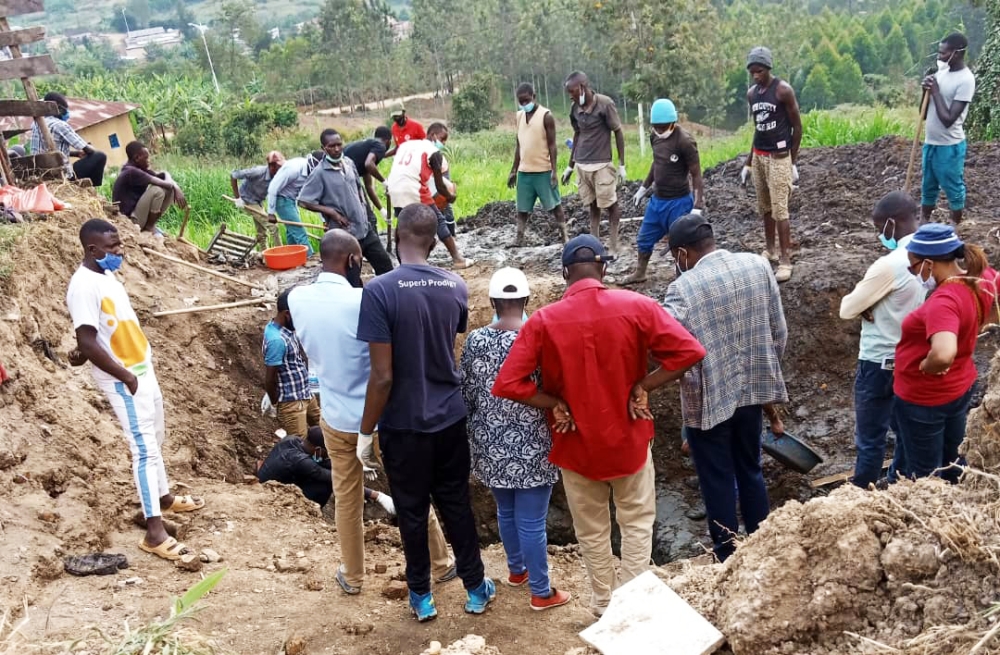Residents of Gitwe exhuming Genocide victims from a mass grave in 2021. File