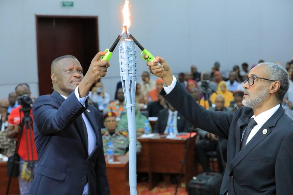 Charles Karamba the Ambassador  of Rwanda and Ali Hassan Bahdon, Minister of Justice of Djibouti  light the Flame of Remembrance during the commemoration of the 1994 Genocide against the Tutsi, in Djibouti on Thursday, April 18. Courtesy