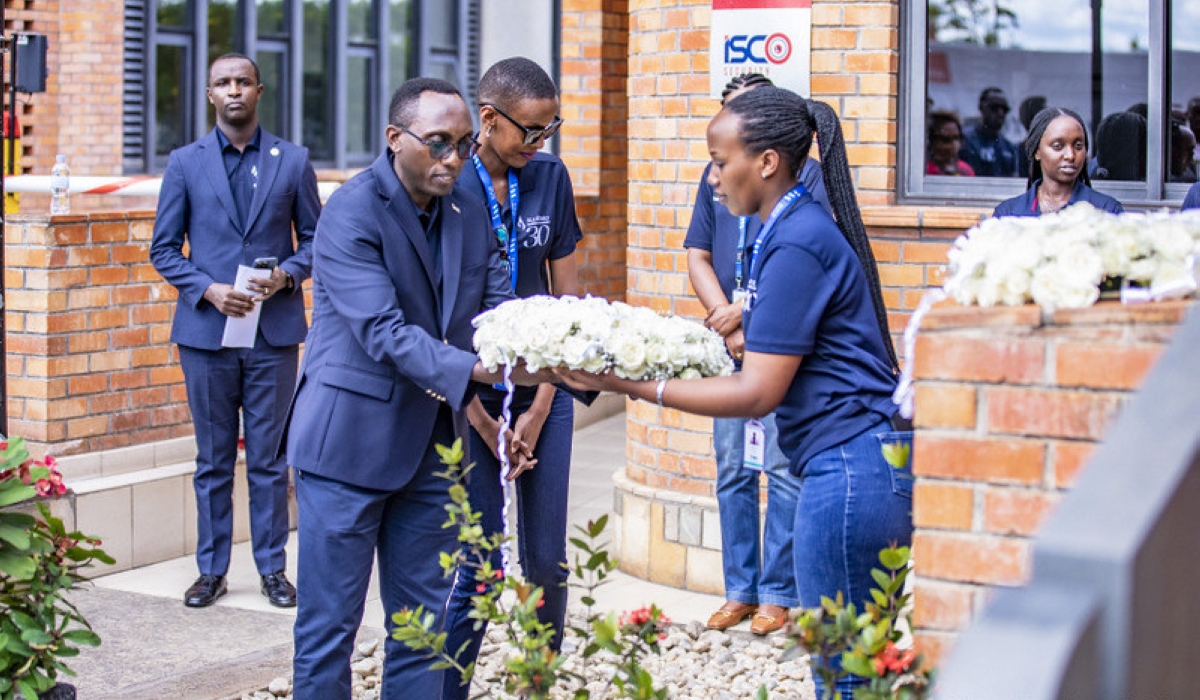 Benjamin Mutimura - Chief Executive Officer - I&M Bank (Rwanda) lays a wreath at the memorial site constructed at the bank&#039;s compound to honour former staff who were killed