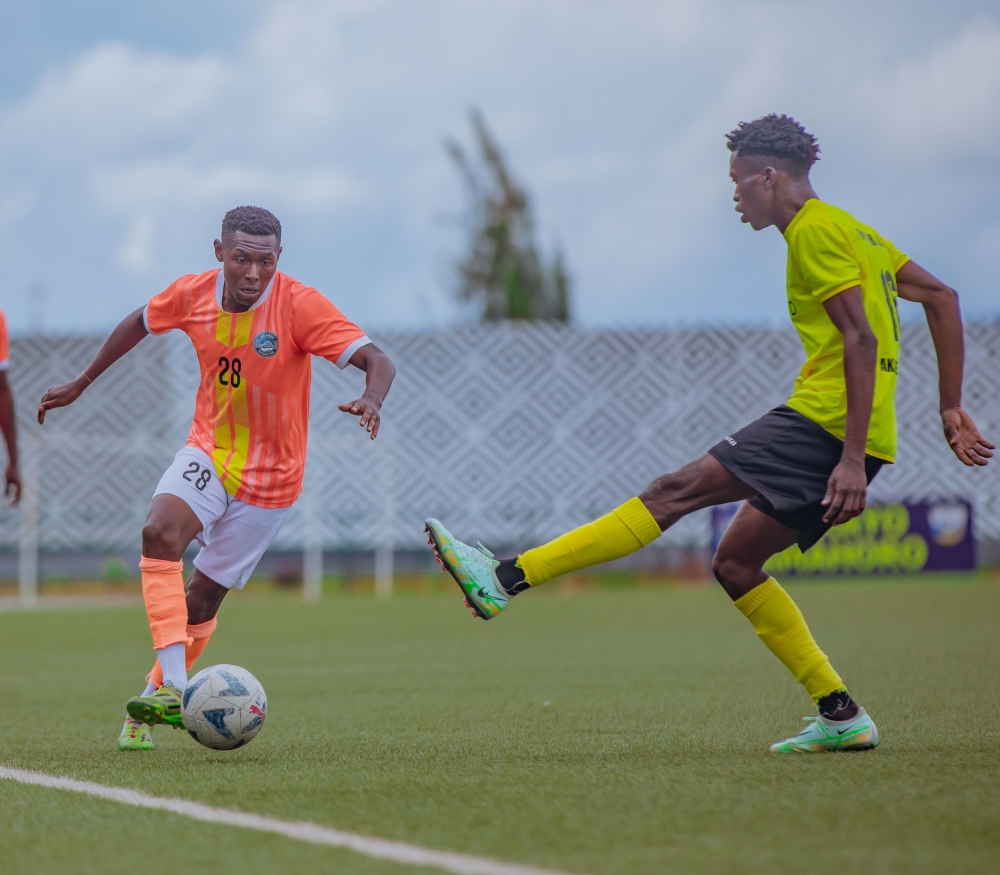 AS Kigali&#039;s midfielder Janvier Benedata tries to dribble past Mukura Victory Sports defender during a goalless draw at Huye Stadium. Courtesy
