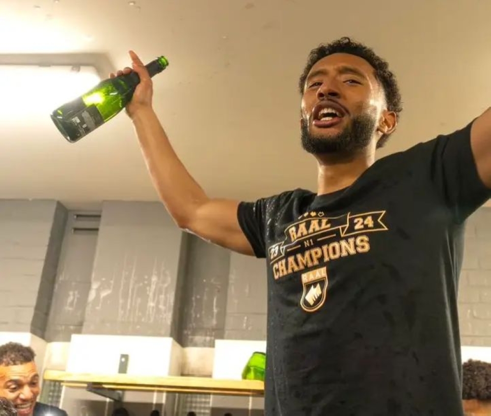 Talented midfielder Samuel Gueulette celebrates with a champagne in the dressing room after his club Raal La Louviere won the 2023/24  Belgian 1st National League.