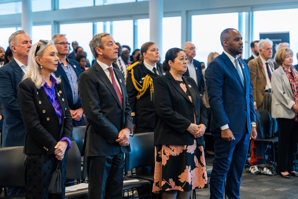 Mourners observe a moment of silence to pay tribute to victims of the Genocide against the Tutsi in New Zealand on Saturday, April 20