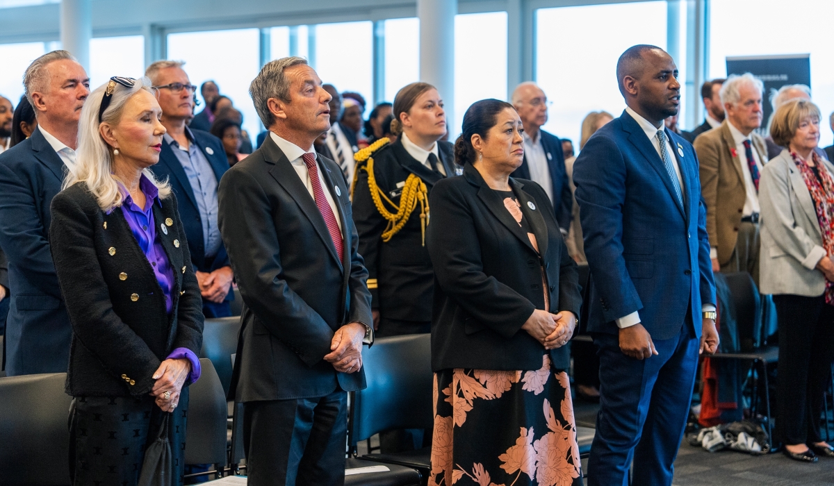 Mourners observe a moment of silence to pay tribute to victims of the Genocide against the Tutsi in New Zealand on Saturday, April 20